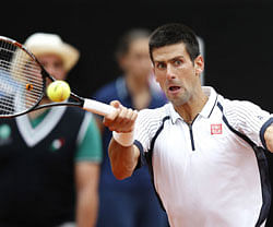 Novak Djokovic of Serbia hits a return to Alexandr Dolgopolov of Ukraine during their men's singles match at the Rome Masters tennis tournament May 16, 2013. REUTERS