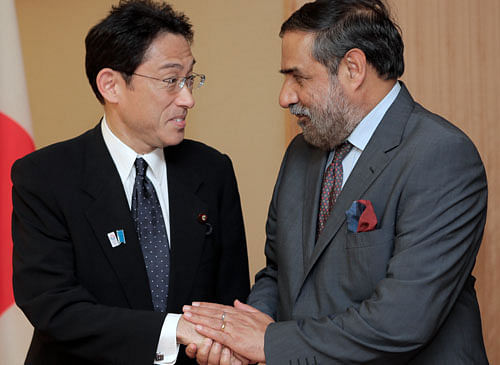 Indian Commerce and Industry Minister Anand Sharma, right, shakes hands with Japanese Foreign Minister Fumio Kishida prior to their meeting at Foreign Ministry in Tokyo, Friday, May 17, 2013. (AP Photo/