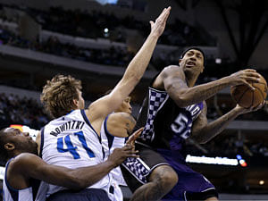 Dallas Mavericks' Elton Brand, from left, Dirk Nowitzki (41) of Germany and Shawn Marion, center rear, defend as Sacramento Kings' James Johnson (52) goes up for a shot in the first half of an NBA basketball game Wednesday, Feb. 13, 2013, in Dallas. AP Photo