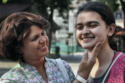 Bhuwanya celebrates with her mother as she topped this year's CISCE board exam in12th with 99% marks in Dehradun on Friday. PTI Photo