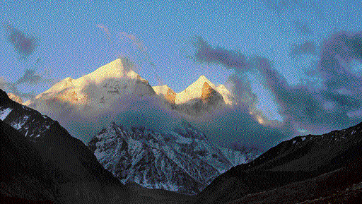 Divine: Clouds descend on the snow-peaked Himalayas. Photo By Authors.