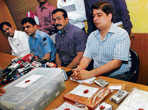 Mumbai Police display confiscated laptop and other articles from Sreesanth's room and mobiles from bookies at a press conference in Mumbai on Saturday. PTI