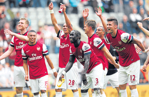 thrilling end: Arsenal players celebrate their win over&#8200;Newcastle United in Sunday's EPL match that secured them a place in next season's Champions League. AFP