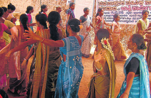 Women participants perform a cultural programme at Labour Day and neoliterates monthly progress meeting, at Beeriga Gram Vikasa Kendra in Bannur Gram panchayat on Sunday.