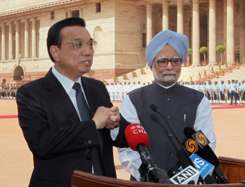 Chinese Premier Li Keqiang talks to the media as Prime Minister Manmohan Singh looks on after his ceremonial welcome at Rashtrapati Bhavan in New Delhi on Monday. PTI Photo