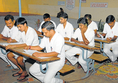 Studious: Inmates of Central Prisons, Mysore, who have opted for courses with Karnataka&#8200;State Open University (KSOU), prepare for examinations, in Mysore. DH Photo