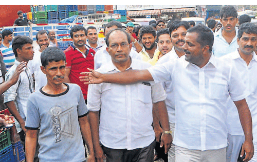 Minister for Health and Family&#8200;Welfare U T Khader interacts with vendors at Central Market on Monday.