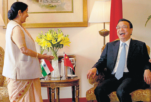 Lighter moment: Chinese Premier Li Keqiang (R) and Leader of the Opposition in the Lok Sabha Sushma Swaraj at a meeting in New Delhi on Monday. PTI