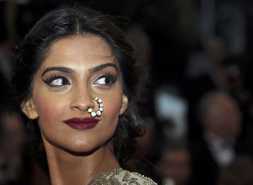 Bollywood actress Sonam Kapoor poses on the red carpet as she arrives for the screening of the film 'The Great Gatsby' and for the opening ceremony of the 66th Cannes Film Festival in Cannes May 15, 2013. The Cannes Film Festival runs from May 15 to May 26. REUTERS