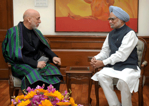 Prime Minister Manmohan Singh talks with President of Afghanistan Hamid Karzai, in New Delhi on Tuesday. PTI Photo