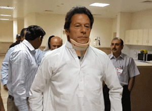 In this handout photo provided by the Shaukat Khanum Memorial Hospital Pakistan's cricketer turned politician Imran Khan, leader of Pakistan Tehreek-e-Insaf party leaves the hospital in Lahore, Pakistan on Wednesday, May 22, 2013. Khan left the hospital Wednesday, more than two weeks after he suffered serious back injuries in a fall from a forklift at a campaign event, a spokesman said. (AP Photo/Shaukat Khanum Hospital)