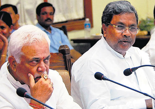 Chief Minister Siddaramaiah and Higher Education Minister  R V Deshpande at a review meeting in Bangalore on  Wednesday. KPN