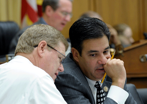House Judiciary Committee members Rep. Raul Labrador, R-Idaho, right, and Rep. Mark Amodei, R-Nev. talk on Capitol Hill in Washington, Wednesday, May 22, 2013, during the committee's hearing on immigration reform. (AP Photo/