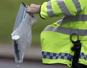 A police officer carries an evidence bag containing a knife near the scene of the killing of a British soldier in Woolwich, southeast London May 23, 2013. REUTERS