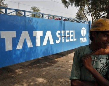 A labourer stands outside a Tata Steel stockyard in Chandigarh May 23, 2013.  Credit: Reuters