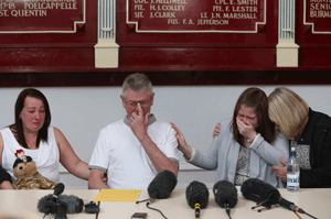 Family members of murdered soldier Lee Rigby (L-R) his mother and stepfather Lyn and Ian Rigby, his wife Rebecca Rigby and her mother Susan Metcalfe, react as his stepfather reads a statement at a news conference at the Royal Regiment of Fusiliers headquarters in Manchester May 24, 2013. Britain's security services faced questions on Friday over whether they could have done more to prevent the murder of a soldier hacked to death in a busy London street after it emerged that his suspected killers were known to intelligence officers. REUTERS