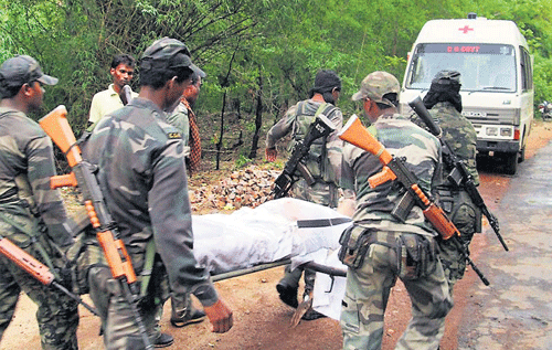 Security personnel carry the body of one of the victims of Saturday's Maoist attack in a densely forested area of Bastar in Chhattisgarh on Sunday. AP