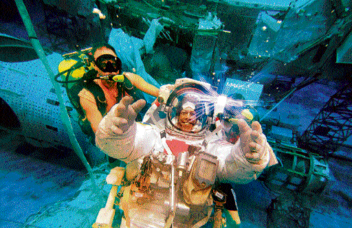 Another day's work : Astronaut Mike Fossum participating in spacewalk training in the waters of the Neutral Buoyancy Laboratory near NASA's Johnson Space Center. (Photo courtesy: NASA)