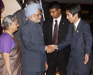 Prime Minister Manmohan Singh with his wife Gursharan Kaur being received by Japan's Parliamentary Vice Minister for Foreign Affairs Minoru Kiuchi upon his arrival at Haneda International Airport in Tokyo, Japan on Monday. PTI Photo