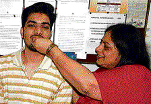 Paras Sharma, who is all-India topper in the Class XII CBSE exams results, with his mother in New Delhi on  Monday. PTI