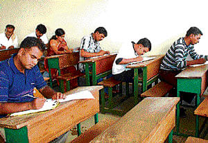 Convicts in Central Jail at Hindalga appear for their degree examination at the Maratha  Mandal College in Belgaum on Wednesday. DH Photo