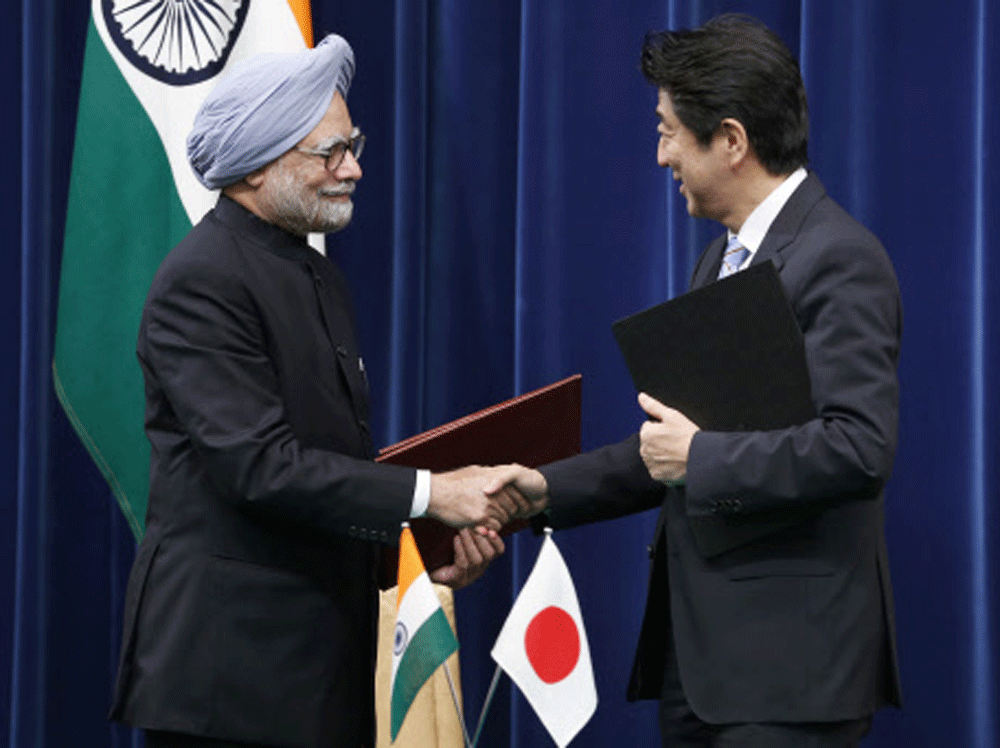 Prime Minister Manmohan Singh shakes hands with his Japanese counterpart Shinzo Abe after they exchange documents they just signed at a ceremony at the prime minister's office in Tokyo, Wednesday, May 29, 2013. AP Photo