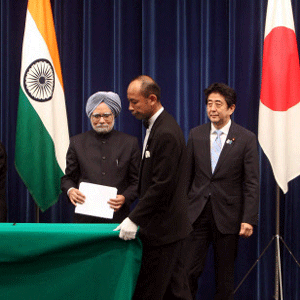 Prime Minister Manmohan Singh with his Japanese counterpart Abe Shinzo look on as officials set a table for joint press conference in Tokyo, Japan on Wednesday. PTI Photo