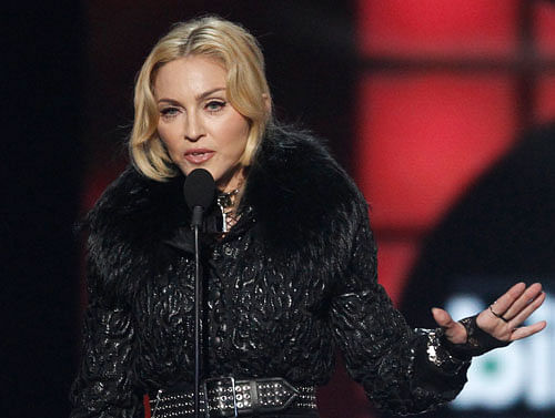 Madonna accepts the award for 'Top Touring Artist' onstage during the Billboard Music Awards at the MGM Grand Garden Arena in Las Vegas, Nevada May 19, 2013. REUTERS