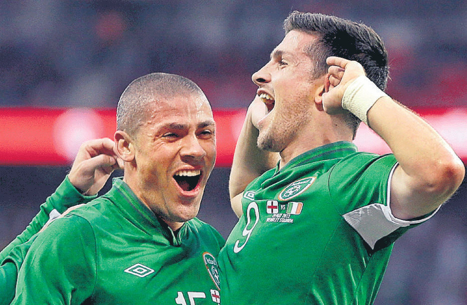 Fine header : Ireland's Shane Long (left) celebrates after scoring the opening goal against England on Wednesday. AP Photo.