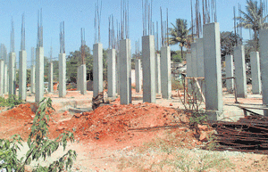 Work on the residential quarters for urban poor is going on at snail's pace at Subramanyapura in Uttarahalli. DH Photo