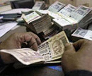 Rupee hits one-year low of 56.58, tumbles 20 paise vs dollar