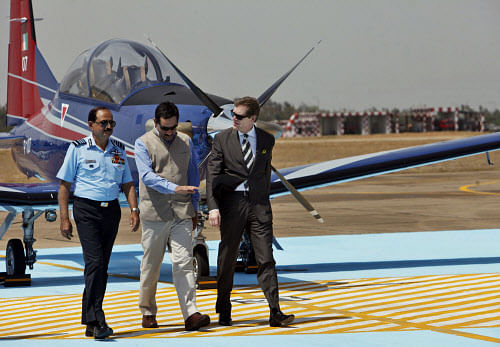 Minister of State for Defense, Jitendra Singh, center, walks with Air Force Chief N.A.K. Browne, left, and Ambassador of Switzerland Linus Van Caftermur, right, in front of Swiss made Pilatus PC-7 aircraft during the Induction Ceremony at Dundigal, 40 kilometers (25 miles) from Hyderabad, India, Friday, May 31, 2013. Ten PC-7s have been inducted into Indian Air Force (IAF) as the Basic trainer for new pilots. (AP Photo)