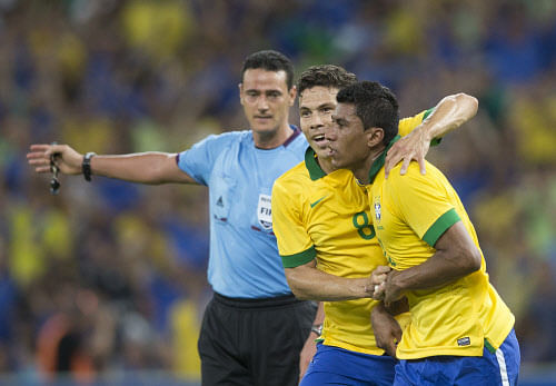 Brazil's Paulinho, right, celebrates with teammate Hernanes after scoring during a friendly soccer game against England at the Maracana stadium, in Rio de Janeiro, Brazil, Sunday, June 2, 2013. Paulinho volleyed a late equalizer for Brazil to draw 2-2 with England on Sunday and prevent the 2014 World Cup hosts from losing its opening match at the revamped Maracana stadium..(AP Photo)