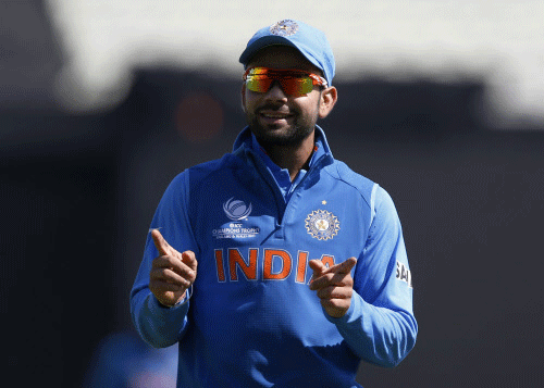 Virat Kohli reacts to cheering from supporters during the ICC Champions Trophy warm-up cricket match between India and Sri Lanka, at Edgbaston cricket ground in Birmingham, England, Saturday, June 1, 2013. AP Photo