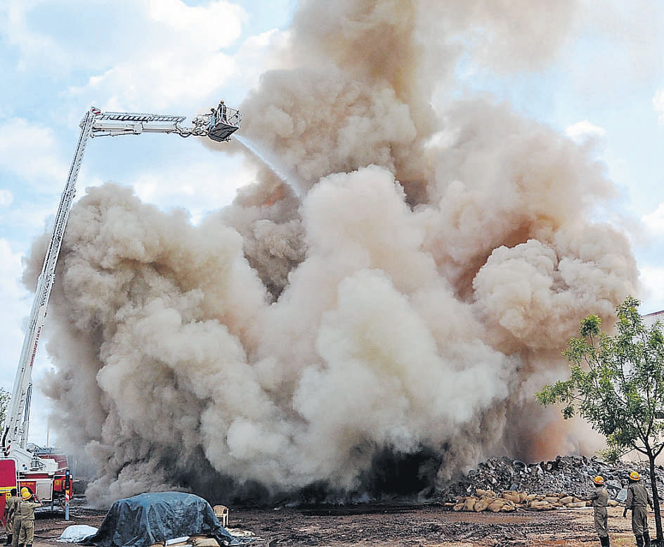 gOING, GOING, GONE: The cold storage facility building, which caught fire due to an electrical short circuit, collapsed at the  Industrial area on Bangalore Road in Bellary on Monday. kpn