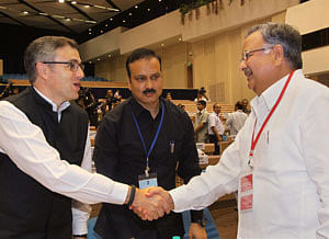 Chhattisgarh Chief Minister Raman Singh shakes hand with J&K Chief Minister Umar Abdullah during the Chief Minister's Conference on Internal Security in New Delhi on Wednesday. PTI Photo