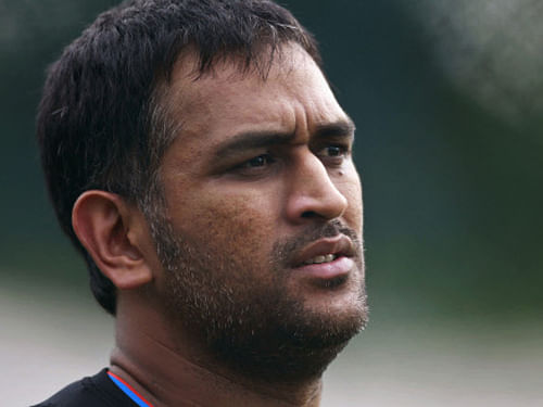 FILE- In this Aug.19, 2012 file photo, Indian cricket captain Mahendra Singh Dhoni stands on the field during a practice session in Hyderabad, India. Dhoni's reported financial association with a sports management firm has come under media scrutiny amid the sharper focus on conflicts of interest among the country's cricket elite. AP Photo