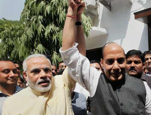 BJP President Rajnath Singh with Gujarat CM Narendra Modi after a meeting at his residence in New Delhi on Wednesday. PTI Photo