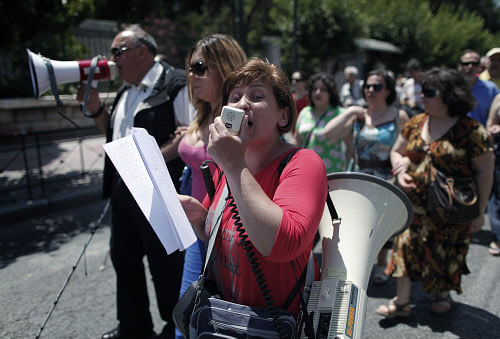 A blind protester chants slogans using a loudspeaker in central Athens on Wednesday, June 5, 2013. Blind groups marched to the office of conservative Prime Minister Antonis to protest ongoing health care benefit cuts in the bailed out country. Debt inspectors from the EU and IMF returned to Athens this week to monitor the country's painful austerity program. (AP Photo)
