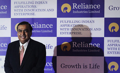 Mukesh Ambani, chairman of Reliance Industries Limited, poses for photographers before addressing the annual shareholders meeting in Mumbai June 6, 2013. India's Reliance Industries Ltd plans to invest 1.5 trillion rupees ($26.4 billion) in its businesses over three years, Ambani told shareholders on Thursday. REUTERS