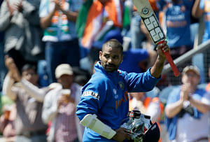 India's Shikhar Dhawan waves his bat to the crowd after he was out for 114 runs playing against South Africa during their group stage ICC Champions Trophy cricket match in Cardiff, Wales, Thursday, June, 6, 2013. (AP Photo/Alastair Grant)