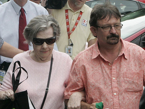 Powerball winner Gloria C. Mackenzie, 84, left, leaves the lottery office escorted by her son, Scott Mackenzie, after claiming a single lump-sum payment of about $370.9 million before taxes on Wednesday, June 5, 2013, in Tallahassee, Fla. Officials say she is the largest sole lottery winner in U.S. history. She did not speak to reporters outside lottery headquarters, leaving in a silver Ford Focus with family members. AP Photo.