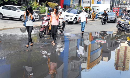 pathetic condition Pedestrians are having a tough time walking down Church Street.  DH PHotos by Dinesh S K