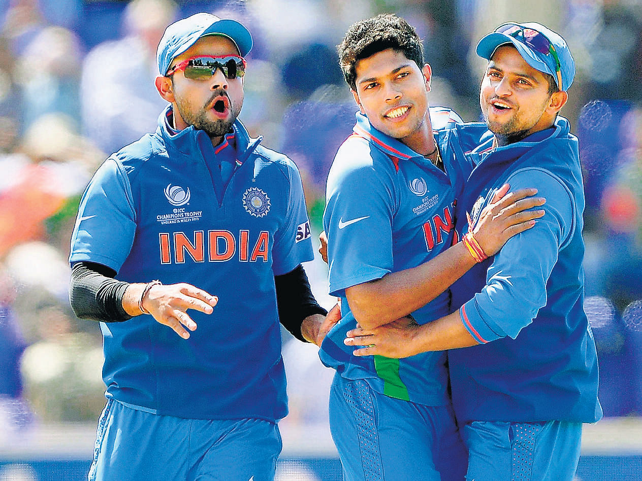 jubilant: Umesh Yadav (centre), Suresh Raina (right) and Virat Kohli celebrate a South African wicket on Thursday. AP