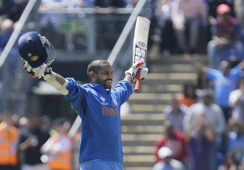 Shikhar Dhawan reacts as he reaches 100 runs not out as he plays against South Africa during their group stage ICC Champions Trophy cricket match in Cardiff, Wales, Thursday, June, 6, 2013. (AP Photo)
