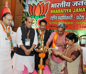 BJP President Rajnath Singh and BJP senior leader Arun Jaitley look on as Goa CM Manohar Parikar and leader of Opposition in Lok Sabha, Sushma Swaraj lighting the lamp at the party's National Office Bearer and States President's meet, at Panaji in Goa on Friday. PTI Photo