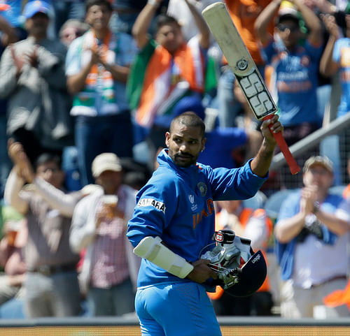 Shikhar Dhawan waves his bat to the crowd after he was out for 114 runs playing against South Africa during their group stage ICC Champions Trophy cricket match in Cardiff, Wales, Thursday, June, 6, 2013. (AP Photo