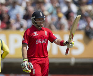 England's Ian Bell holds up his bat to acknowledge reaching 50 runs during the ICC Champions Trophy group A cricket match between England and Australia at Edgbaston cricket ground in Birmingham, England, Saturday, June 8, 2013. AP Photo