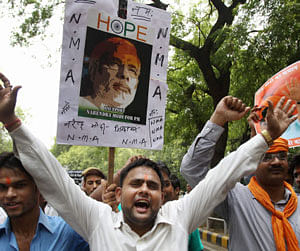Supporters of Gujarat Chief Minister Narendra Modi shout slogans against senior BJP leader LK Advani during a protest outside his residence in New Delhi on Saturday. PTI Photo