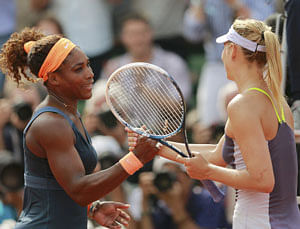 Serena Williams of the U.S. shakes hands with Maria Sharapova (R) of Russia after winning their women's singles final match at the French Open tennis tournament at the Roland Garros stadium in Paris June 8, 2013. Serena Williams proved an irresistible force once more as she powered past Maria Sharapova 6-4 6-4 to win the French Open for the second time on Saturday - 11 years after her first triumph. REUTERS